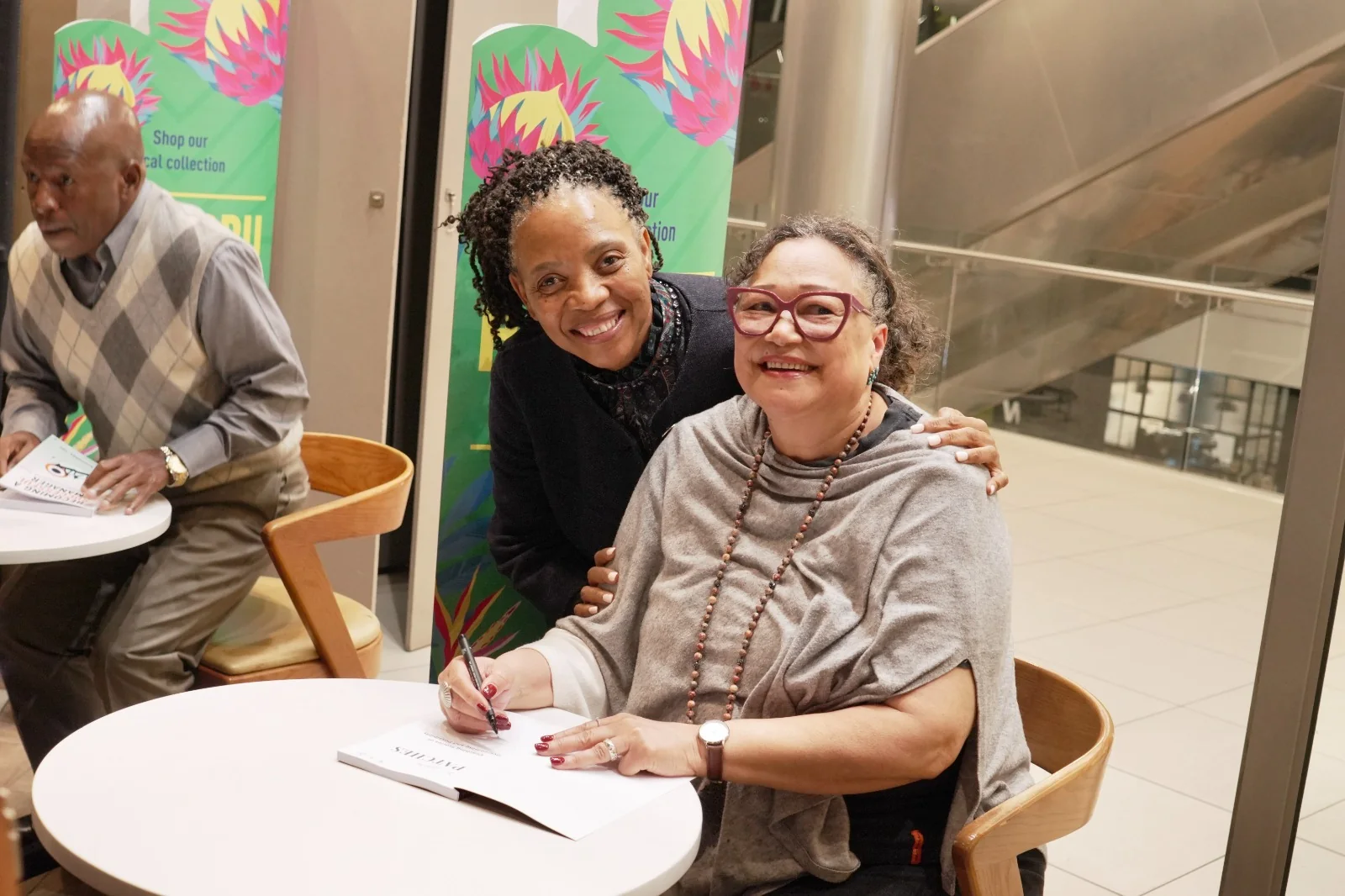 Alicia S. Pieterse and a reader smiling together at the book signing